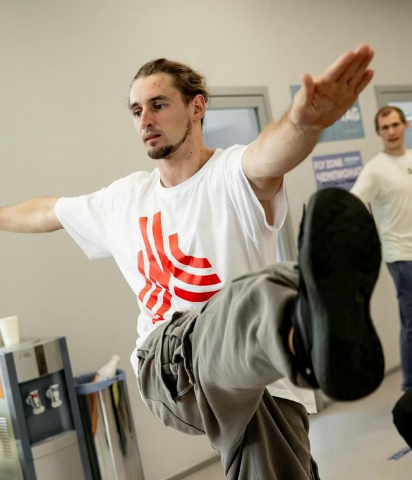 A man in a focused pose during a workout session.